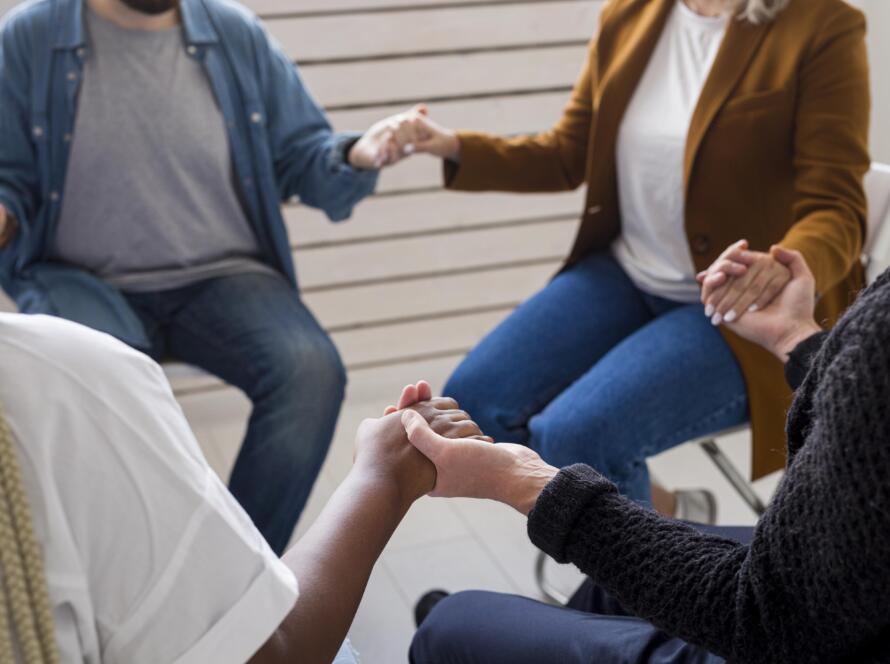 close up community holding hands scaled