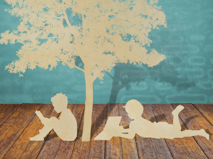 Paper cut of children read a book under tree