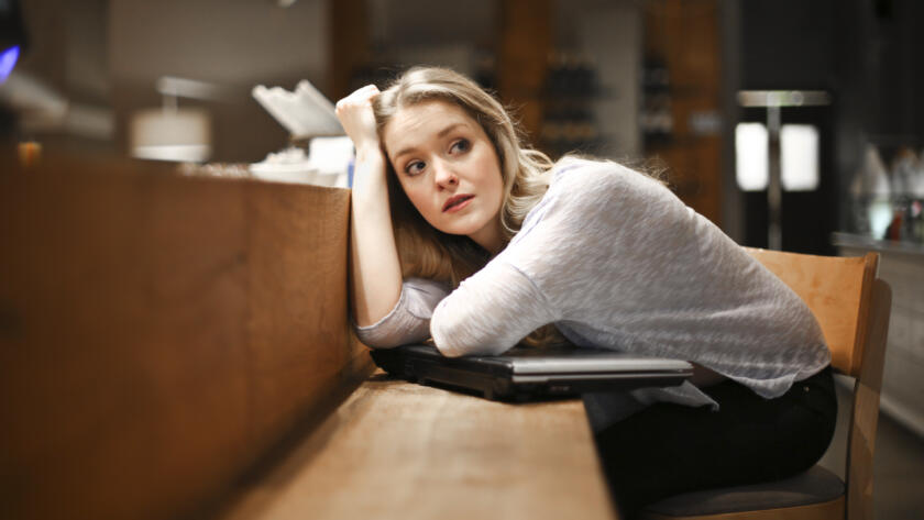 portrait of a girl with a computer in a cafe